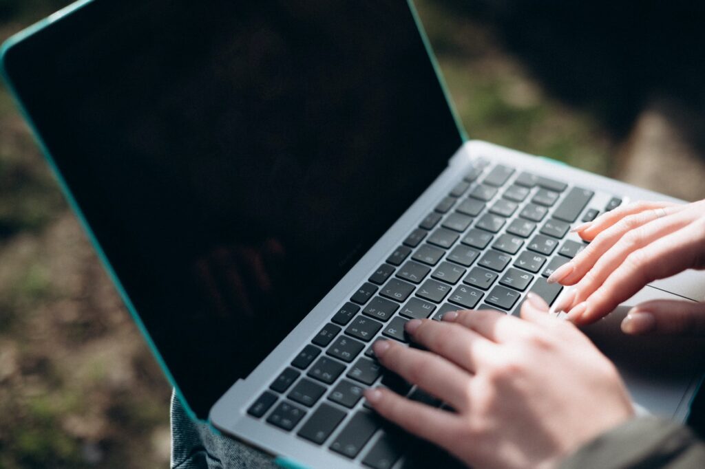 a person typing on a laptop computer