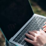 a person typing on a laptop computer