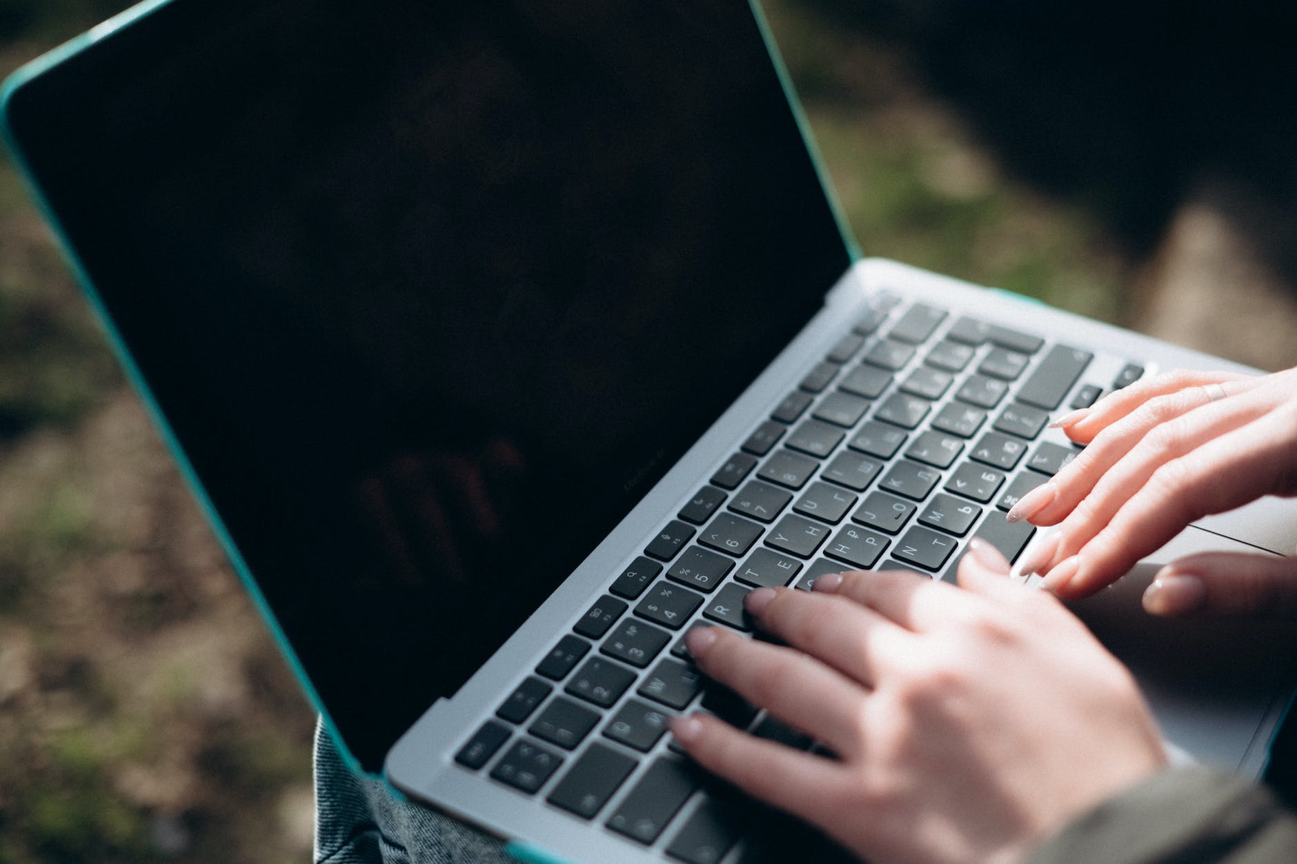 a person typing on a laptop computer